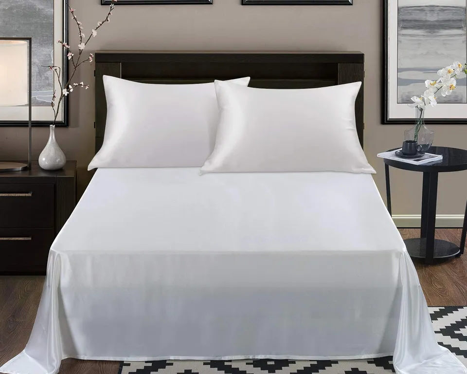 A made bed with two ivory Alaska Bear silk pillowcases